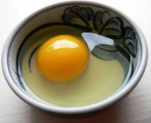 Сырое яйцо в тарелке